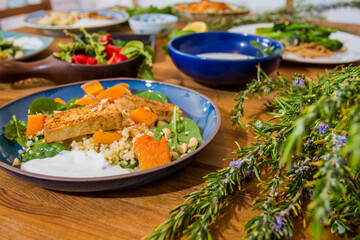 Grilled vegetables and healthy food dishes on a fancy wooden table. Mediterranean food dishes with asparagus, tofu, seitan and Halloumi cheese. Gluten free recipes for fitness persons. Food Background