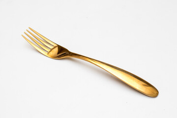 Top view of golden fork isolated white background.