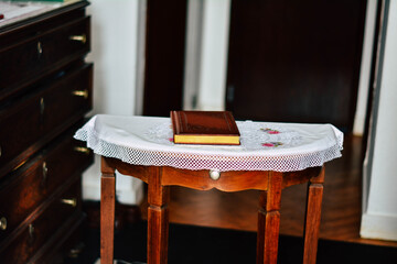 a small table in the middle of the room with a brown notebook. recording table