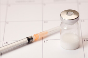 Syringe, vaccine vial, and plane, in 2021 calendar