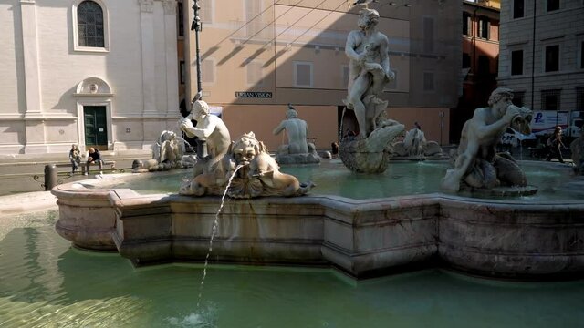 The round about view on the fountain of the Moor with the figure of Neptune and four smaller Tritons blowing into two shells from which water flows.