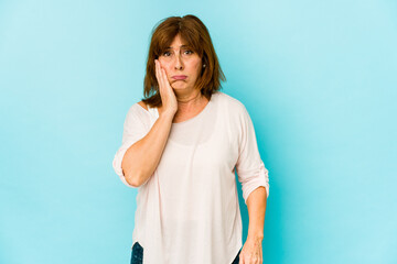 Senior caucasian woman isolated blows cheeks, has tired expression. Facial expression concept.