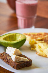 Breakfast dish with omet brown whole bread with cheese and avocado