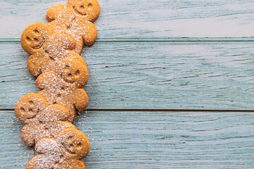 a stack of gingerbread cookies on a blue wooden table with copyspace - 396663445