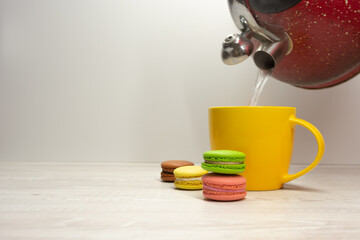 macaroons on the background of a yellow cup