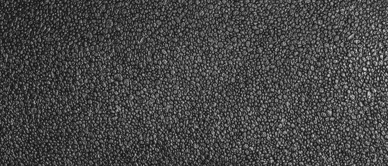 Fototapeta premium Panoramic view of the texture of dark packaging foam. Close-up of the foam surface.