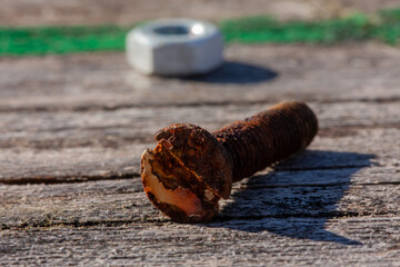 old rusty screw on a old wooden table