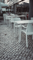empty tables in cafes that were closed during the Pandemic. lack of people on the street and in cafes