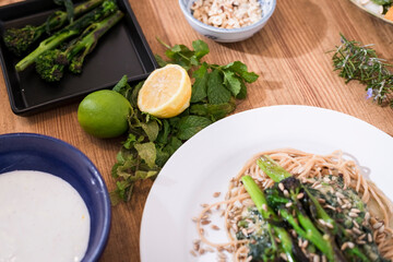 Grilled vegetables and healthy food dishes on a fancy wooden table. Mediterranean food dishes with asparagus, tofu, seitan and Halloumi cheese. Gluten free recipes for fitness persons. Food Background