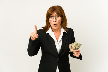 Middle age caucasian business woman holding banknotes isolated having an idea, inspiration concept.