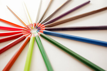 Multicolored pencils on white background