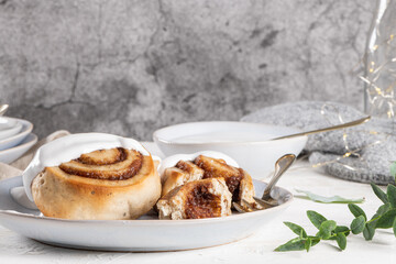 Cinnamon rolls or cinnabon  with icing for Christmas. Homemade traditional winter festive dessert buns. Pastry food for breakfast on white background