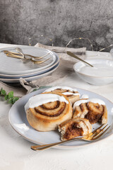 Cinnamon rolls or cinnabon  with icing for Christmas. Homemade traditional winter festive dessert buns. Pastry food for breakfast on white background