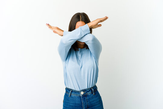 Young mixed race woman keeping two arms crossed, denial concept.