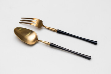 Top view of golden spoon and fork isolated white background.