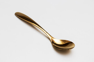 Top view of golden spoon and fork isolated white background.