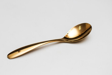 Top view of golden spoon and fork isolated white background.