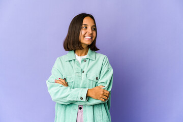 Young mixed race woman smiling confident with crossed arms.