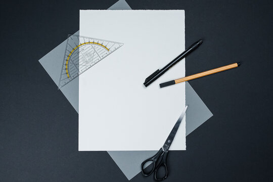 school supplies on a white-grey-black background with blank space