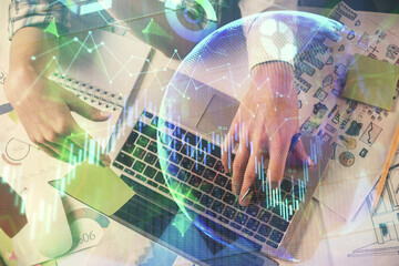 Double exposure of man and woman working together and forex graph hologram drawing. Financial analysis concept. Computer background. Top View.