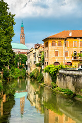Fototapeta na wymiar Torre Bissara reflected in the Retrone River in Vicenza, Italy