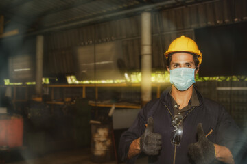 Industrial technicians put on safety equipment and masks while working in the factory to prevent...