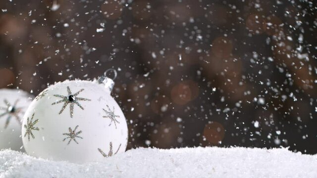 Christmas Still Life with Defocused Lights in Background and Snowflakes Falling. Super Slow Motion Filmed on High Speed Cinema Camera at 1000 fps.