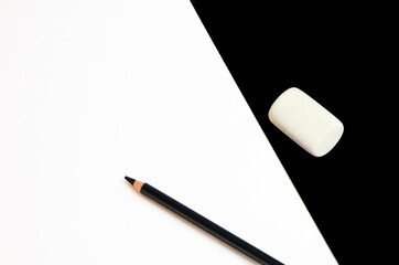 black pencils on a black and white background with an elastic band
