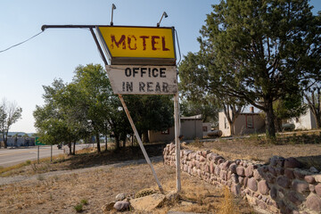 Generic sign for a motel - office in rear, now abandoned