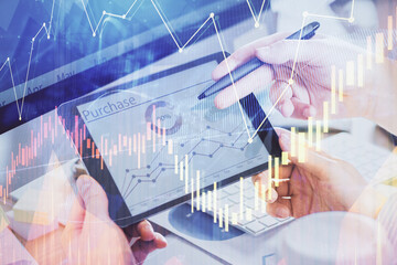 Double exposure of man's hands holding and using a phone and financial chart drawing. Market analysis concept.