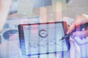 Obraz premium Double exposure of man's hands holding and using a phone and financial chart drawing. Market analysis concept.