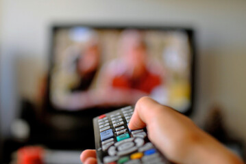 Close up of hand using a TV Remote Control