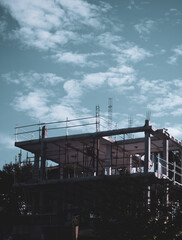 Fototapeta na wymiar building under construction with partly cloudy sky