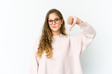 Young caucasian woman showing thumb down, disappointment concept.