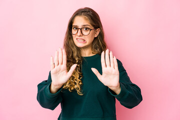 Young caucasian woman rejecting someone showing a gesture of disgust.