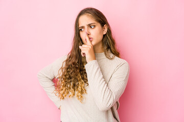 Young caucasian woman keeping a secret or asking for silence.