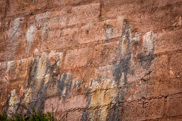 Rain water leaks on the wall causing damage and peeling paint