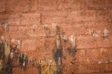 Rain water leaks on the wall causing damage and peeling paint