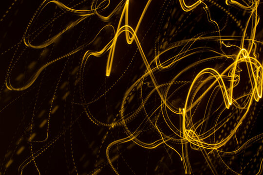 Yellow Light Streaks On A Black Background (long Exposure).