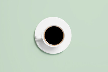 Cup of coffee on a mint background. Coffee cup top view.