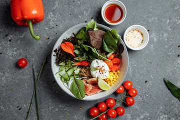 fresh healthy light breakfast, business lunch. Breakfast with poached egg, buckwheat, red fish, fresh salad, cucumbers, business lunch concept