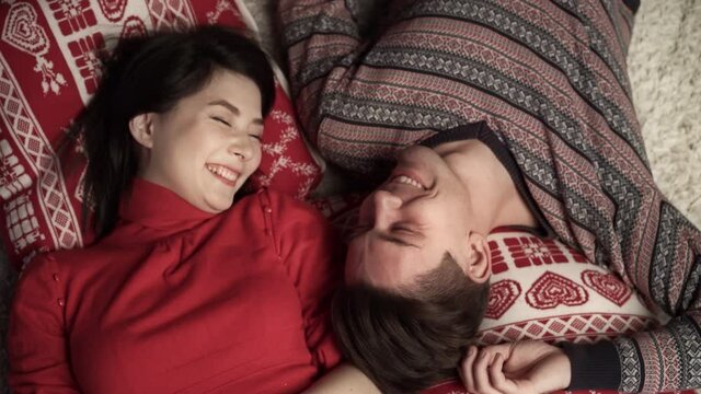Happy couple enjoying xmas and lying head to head. Top view. Relationship, family, christmas, new year, holiday concet.