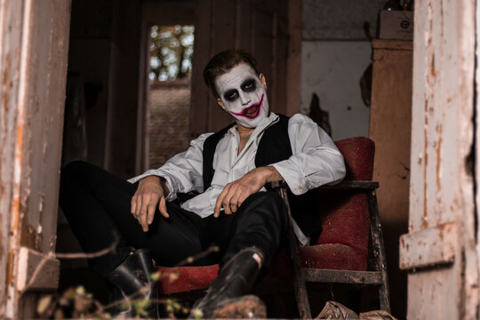 Halloween make up mask. Young man in joker mask.
