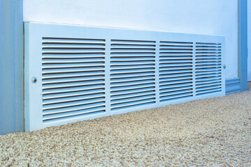 Cold air return vent Inside residencial home, air vent on a white wall with carpet.