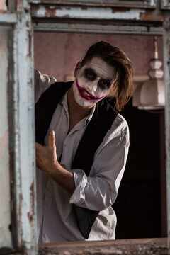 Halloween make up mask. Young man in joker mask.