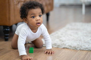 Happy African American Little baby boy crawling and looking for some thing to learn - obrazy, fototapety, plakaty