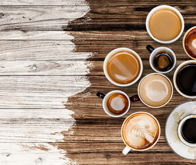 Coffee mugs on a pale white and brown wooden textured background