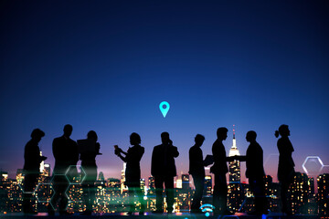 Group of silhouetted business people talking at night