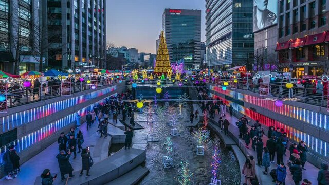Seoul, South Korea - December 23, 2018: Cheonggyecheon stream, people walking on beautiful Christmas lights at night in Seoul, South Korea