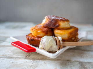 A slide of homemade pancakes with honey and powdered sugar on a plate in the shape of a christmas tree